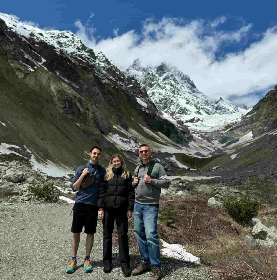 guided hiking tours in the caucasus mountains - book with zuratour Group of tourists hiking with professional guide in the snowy Caucasus mouintains of Georgia, Kazbegi region . a signature mountain trekking experience provided by zuratour.com