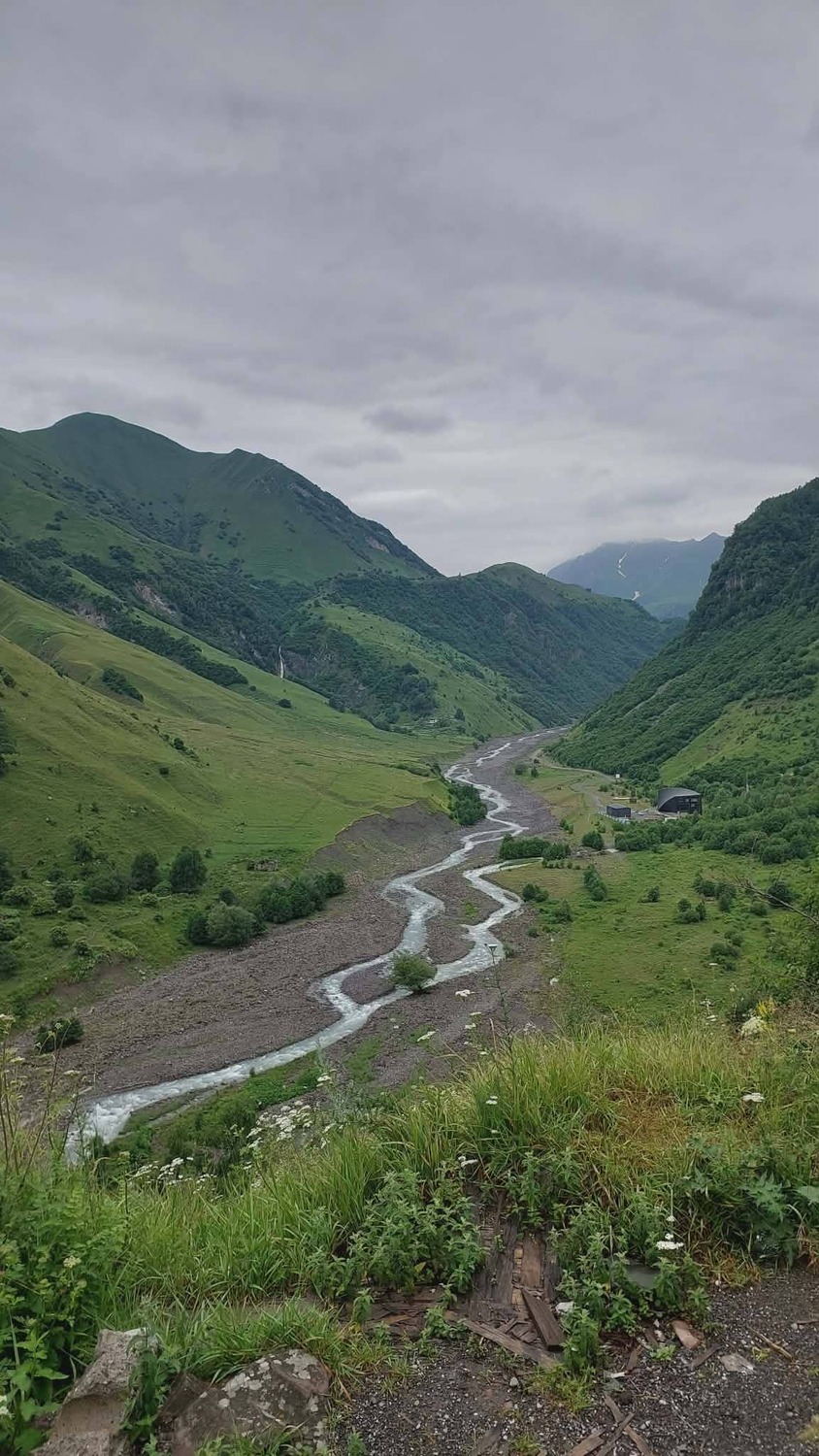 scenic green landscape of Truso valley with winding river and mountains by zuratour.com
